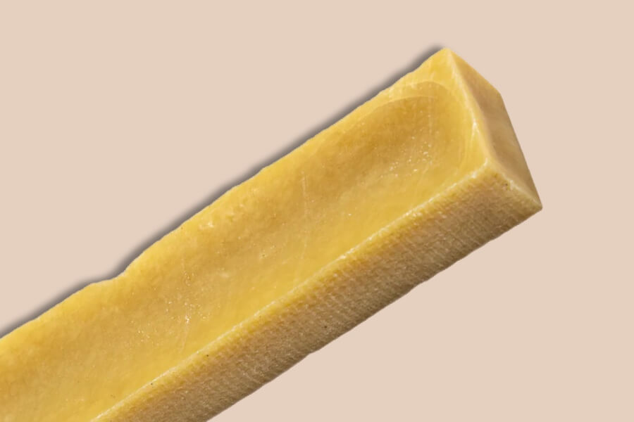 Close up of a natural yak chew showing its dense, long lasting texture