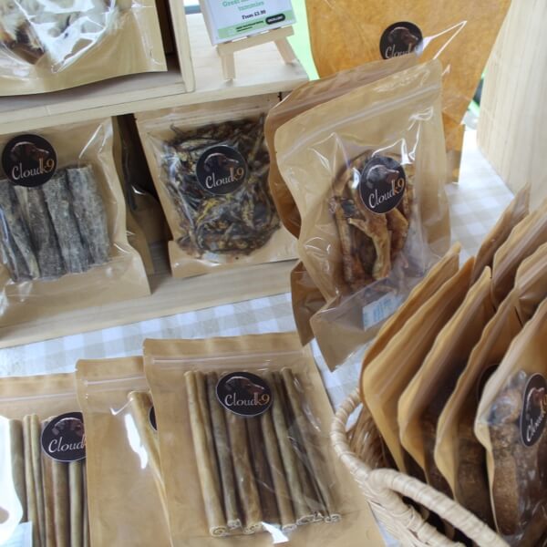 Cloud K9 natural dog treats and chews in kraft packaging at a local market stall