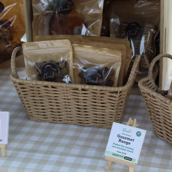 Cloud K9 gourmet dog treats displayed in wicker baskets at an event stall