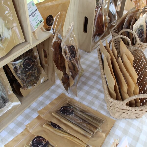 Section of Cloud K9 natural dog chews and treats displayed on a market stall