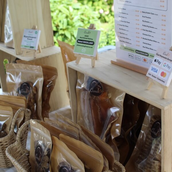 Cloud K9 event stall displaying natural dog treats, chews and nutritional rating signage