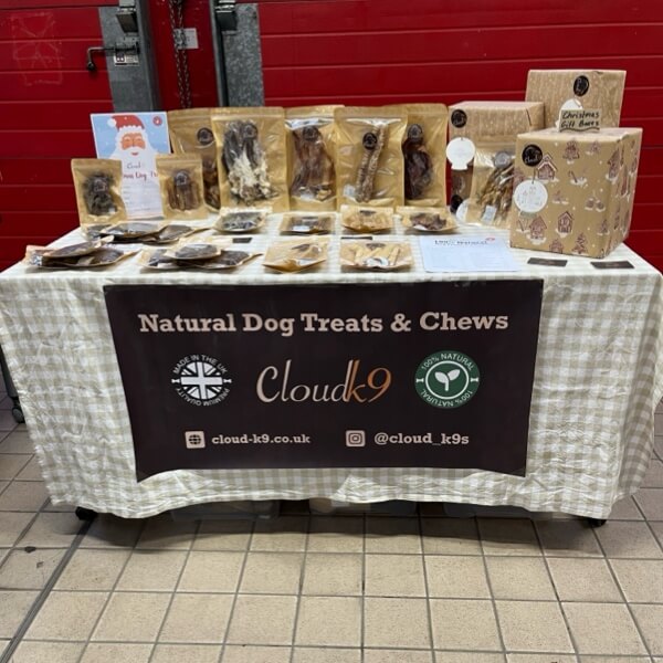 Cloud K9 natural dog treats and chews stall with wicker baskets and branded event signage