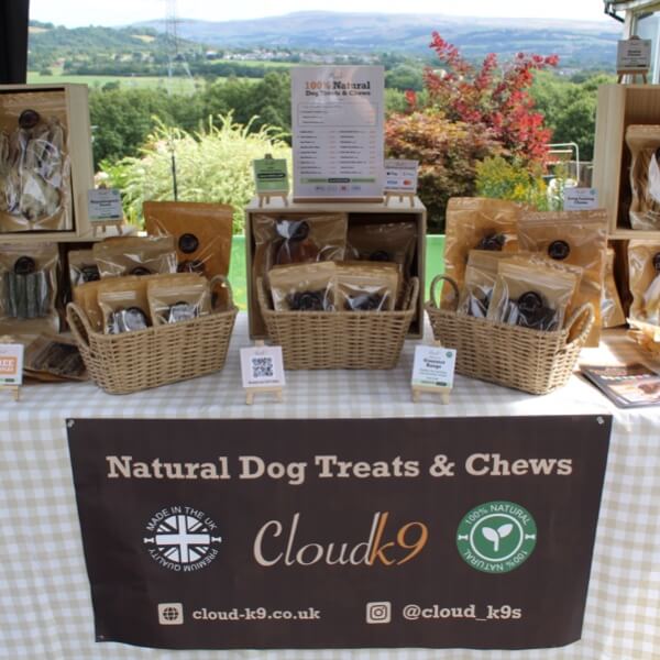 Cloud K9 natural dog treats and chews stall set up at an indoor Christmas market